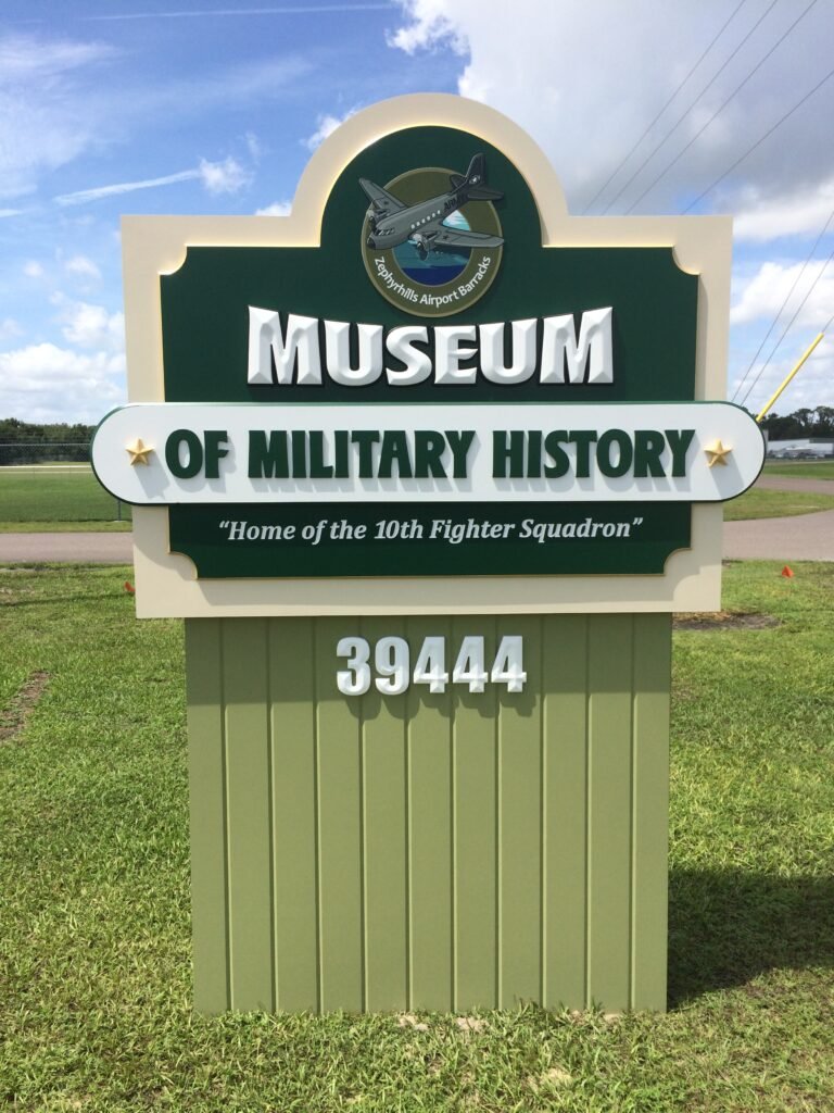 Custom Signage – Zephyrhills Military Museum CNC cut and carved PVC panels and Dimensional Leterring with Printed cnc cut medallion by Skywatch Sign